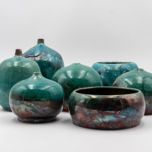 A collection of seven small rake fired ceramic pieces