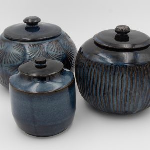 A collection of three lidded jars